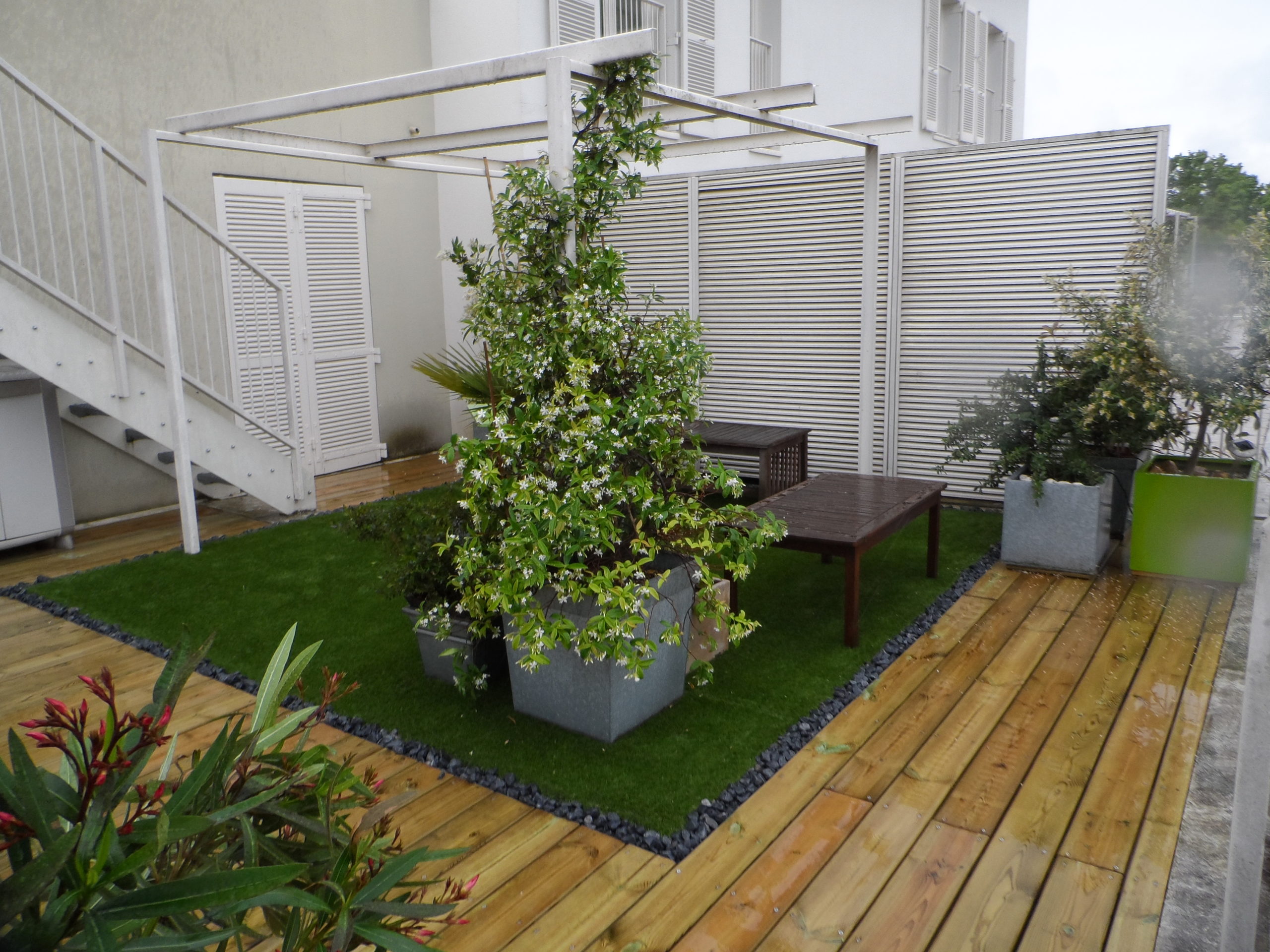 Inclusion de gazon synthétique dans une terrasse en pin